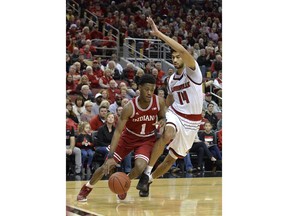 Indiana guard Aljami Durham (1) attempts to drive past the defense of Louisville forward Anas Mahmoud (14) during the first half of an NCAA college basketball game, Saturday, Dec. 9, 2017, in Louisville, Ky.
