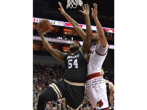 Bryant forward Sabastian Townes (54) goes for a layup past the defense of Louisville forward Anas Mahmoud (14) during the first half of an NCAA college basketball game, Monday, Dec. 11, 2017, in Louisville, Ky.