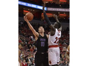 Grand Canyon guard Casey Benson (11) attempts a shot over the defense of Louisville forward Deng Adel (22) during the first half of an NCAA college basketball game, Saturday, Dec. 23, 2017, in Louisville, Ky.