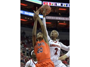 Louisville forward Myisha Hines-Allen (2) battles Tennessee-Martin forward Chelsey Perry (20) for a rebound during the first half of an NCAA college basketball game, Tuesday, Dec. 5, 2017, in Louisville, Ky.