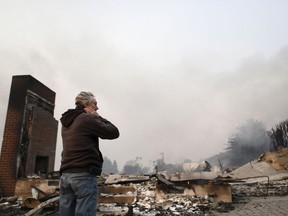 Greg Smith stands amid the ruins of his home after the Thomas fire swept through Ventura, Calif., Tuesday, Dec. 5, 2017.