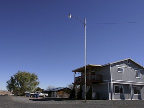 FILE - This Nov. 8, 2008, file photo shows the house in St. Johns, Ariz., where Vincent Romero and Timothy Romans, of San Carlos, Ariz., were found fatally shot. Police said Romero's 9-year-old son, who was 8 at the time, used a rifle to shoot the men as they returned home from work. A judge overseeing the case of the now teenager, who was charged in a double homicide when he was 8 years old, heaped praise on him Wednesday, Dec. 27, 2017, for the progress he's made. He turns 18 on Friday, marking the end of probation.