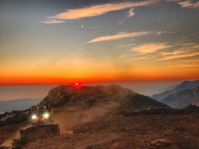 In this photo released by Santa Barbara County Fire Department, a dozer from the Santa Barbara County Fire Department clears a fire break across a canyon from atop Camino Cielo down to Gibraltar to make a stand should the fire move in that direction, Wednesday, Dec. 13, 2017, in the Santa Ynez Mountains area of Santa Barbara, Calif. State fire officials predicted Wednesday night that the Thomas Fire northwest of Los Angeles will continue to grow as it eats up parched brush and hot, dry weather continues.