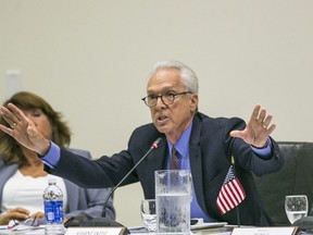 FILE - In this Sept. 17, 2015, file photo, appointed Regent Norman Pattiz, right, addresses members of the University of California's Board of Regents meeting at the UC Irvine Student Center discussing a controversial policy statement on intolerance in Irvine, Calif. At left, Regent Bonnie Reiss. Regent Pattiz was caught on tape in 2016 asking an employee if he could hold her breasts has decided to resign amid growing calls that he step down. In a resignation letter to Regents Chair George Keiffer, first reported by the San Francisco Chronicle, Pattiz said that after 16 years on the board he would retire in Feb. 2018.