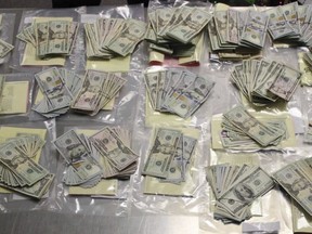 In this Thursday, Dec. 7, 2017, photo released by the Stockton Police Department's Gang Suppression Unit shows evidence, nearly $44,000 in cash after nearly 50 people were arrested in a crackdown on gangs in Stockton, Calif. The sweep was aimed at members of some of south Stockton's most notorious criminal gangs, with names like the MOB, Flyboys, East Coast Crips, Conway Gangsters, Sierra Vista Project and Glock Team. (Stockton Police Department via AP)