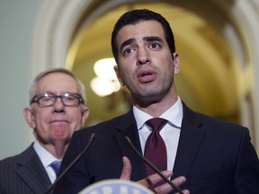 FILE - This Nov. 14, 2016 file photo Rep.-elect Ruben Kihuen, D-Nev.,right, speaks with reporters as Sen. Harry Reid, D-Nev., left, listens on Capitol Hill in Washington. The chairman of the House Democrats' campaign committee called on Kihuen to step down after a report Friday, Dec. 1, 2017, that he allegedly sexually harassed his campaign's finance director.