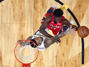 New Orleans Pelicans guard Jrue Holiday (11) goes to the basket against Denver Nuggets forward Wilson Chandler in the first half of an NBA basketball game in New Orleans, Wednesday, Dec. 6, 2017.