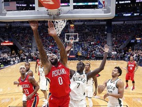 New Orleans Pelicans center DeMarcus Cousins (0) goes to the basket against Milwaukee Bucks center Thon Maker (7) in the first half of an NBA basketball game in New Orleans, Wednesday, Dec. 13, 2017.