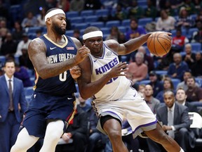 Sacramento Kings forward Zach Randolph, right, drives to the basket against New Orleans Pelicans center DeMarcus Cousins (0) during the first half of an NBA basketball game in New Orleans, Friday, Dec. 8, 2017.