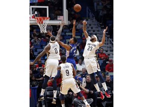 Philadelphia 76ers guard Timothe Luwawu-Cabarrot (7) battles under the basket between New Orleans Pelicans center DeMarcus Cousins (0) and forward Anthony Davis (23) in the first half of an NBA basketball game in New Orleans, Sunday, Dec. 10, 2017.