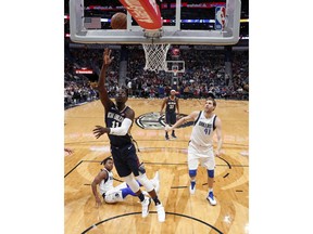 New Orleans Pelicans guard Jrue Holiday (11) goes to the basket in the first half of an NBA basketball game against the Dallas Mavericks in New Orleans, Friday, Dec. 29, 2017.