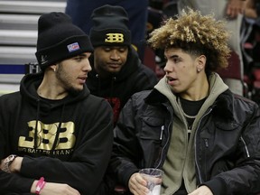 LiAngelo Ball, left, and his brother, LaMelo, talk before a Los Angeles Lakers-Cleveland Cavaliers game in Cleveland on Dec. 14.