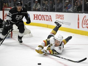 Vegas Golden Knights left wing Brendan Leipsic, right, falls as he passes the puck while under pressure from Los Angeles Kings defenseman Kevin Gravel during the first period of an NHL hockey game, Thursday, Dec. 28, 2017, in Los Angeles.