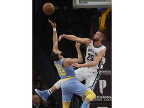 Los Angeles Lakers' Tyler Ennis, left, has his shot blocked by Memphis Grizzlies' Chandler Parsons during the first half of an NBA basketball game, Wednesday, Dec. 27, 2017, in Los Angeles.