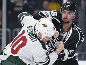 Los Angeles Kings defenseman Kurtis MacDermid, right, fights Minnesota Wild right wing Chris Stewart during the first period of an NHL hockey game in Los Angeles, Tuesday, Dec. 5, 2017.