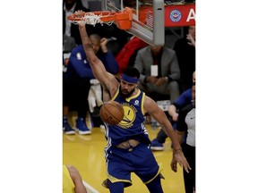 Golden State Warriors center JaVale McGee dunks against the Los Angeles Lakers during the first half of an NBA basketball game in Los Angeles, Monday, Dec. 18, 2017.
