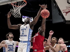 North Carolina forward Theo Pinson (1) and Ohio State forward Jae'Sean Tate (1) battle for a rebound in the first half of an NCAA basketball game in New Orleans, Saturday, Dec. 23, 2017.