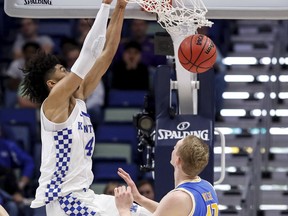 Kentucky forward Nick Richards (4) dunks over UCLA center Thomas Welsh (40) in the first half of an NCAA basketball game in New Orleans, Saturday, Dec. 23, 2017.