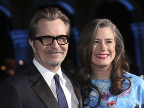 Actor Gary Oldman, left, and his wife Gisele Schmidt pose for photographers upon arrival at the British Independent Film Awards in London, Sunday, Dec. 10th, 2017.
