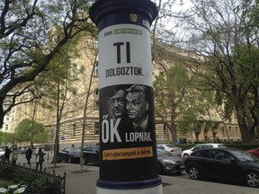 FILE - This April 12, 2017 file photo shows a political billboard of the far-right Jobbik Party in Budapest Hungary that reads: "Jobbik: On the people's side. You work, they steal - that is why salaries are low." The poster shows Prime Minister Viktor Orban, right, and Lorinc Meszaros, one of Hungary's richest people who has attributed his wealth in part to his friendship with Orban. Jobbik party says a huge fine from the state audit office threatens its participation in April's parliamentary elections.