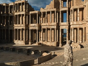 A soldier walks inside the Roman theater in Sabratha, Libya. The site was damaged during recent fighting for the control of the city between Ahmed Dabbashi's militia and a group called the Anti-ISIS FightingRoom.
