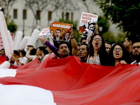 Demonstrators shouts slogans against Keiko Fujimori, daughter of jailed former President Alberto Fujimori, blaming her party for corruption charges against President Pedro Pablo Kuczynski in Lima, Peru, Saturday, Dec. 16, 2017. Kucyznski is scrambling for his political survival as opponents demand he resign over revelations of decade-old payments from Odebrecht, a Brazilian construction company, at the center of Latin America's biggest graft scandal.