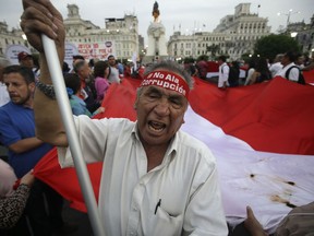 A protester shouts against corruption during a march in Lima, Peru, Wednesday, Dec. 20, 2017. Congressional opposition leaders initiated impeachment proceedings against Peru's President Pedro Pablo Kuczynski after an investigative committee revealed documents showing his private consulting firm received payments from Brazilian construction company Odebrecht more than a decade ago.