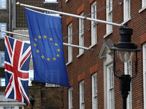 The European Union and British Union flags fly in Westminster in London, Friday, Dec. 8, 2017.  Britain and the European Union have hammered out a deal on the Northern Ireland border, paving the way for Brexit talks to finally move on to the all-important issues of trade and the future relationship between the two.