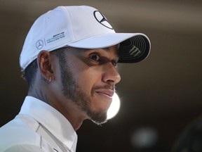 FILE - In this Wednesday, Nov. 29, 2017 file photo, Mercedes Formula One driver Lewis Hamilton of Britain listens to a question from the media during a celebratory event by Petronas in Kuala Lumpur, Malaysia. Mercedes driver Lewis Hamilton credits his car's reliability and a better relationship with his teammate as key factors behind his fourth world title. Hamilton scored points in all Formula One races this season, the first time he has done so.