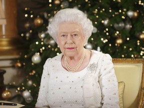 In this photo released on Monday, Dec. 25, 2017, Britain's Queen Elizabeth sits at a desk in the 1844 Room at Buckingham Palace, after recording her Christmas Day broadcast to the Commonwealth, in London. (Pool Photo via AP)