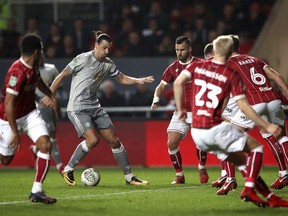 Manchester United's Zlatan Ibrahimovic, centre left, runs with the ball during the English League Cup Quarter Final soccer match between Bristol City and Manchester United at Ashton Gate, Bristol, England, Wednesday, Dec. 20, 2017.