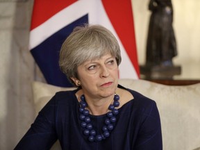 British Prime Minister Theresa May turns to listen to a translator during her meeting with Spanish Prime Minister Mariano Rajoy inside 10 Downing Street in London, Tuesday, Dec. 5, 2017.