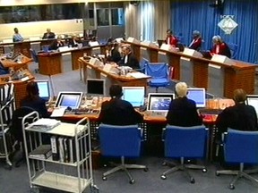 FILE - In this Tuesday Sept. 7, 2004 file image made from TV, Slobodan Milosevic, second from top left, appears before the International Criminal Tribunal for the former Yugoslavia (ICTY) in The Hague, The Netherlands. After nearly a quarter century of prosecuting Balkan wars atrocities, the United Nations' Yugoslav war crimes tribunal is closing down with no fugitives left on the run, many major suspects convicted but denial of crimes and glorification of war criminals still rife in the region. (ICTY, File via AP)