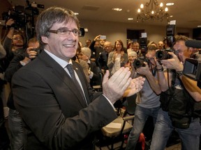 FILE - In this Saturday, Nov. 25, 2017 file photo, ousted Catalan president Carles Puigdemont attends a presentation of the candidate list for the Catalan regional elections in Oostkamp, Belgium. A Spanish judge on Tuesday Dec. 5, 2017, has withdrawn the European arrest warrants for ousted Catalan leader Carles Puigdemont and four members of his former cabinet who were fighting extradition from Belgium.