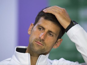 FILE - This is a Wednesday, July 12, 2017 file photo of Serbia's Novak Djokovic as he gestures during a press conference after losing his Men's Singles Quarterfinal Match against Czech Republic's Tomas Berdych on day nine at the Wimbledon Tennis Championships in London. Novak has withdrawn from the Mubadala WTC exhibition event due to pain in his right elbow. The Serbian star was scheduled to return to tennis on Friday, Dec. 29, 2017 after being out of the game for nearly six months.