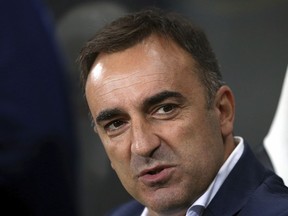 FILE - In this Wednesday, Sept. 23, 2015 file photo, Sheffield Wednesday's manager Carlos Carvalhal awaits the start of the English League Cup third round soccer match between Newcastle United and Sheffield Wednesday at St James' Park, Newcastle, England. Swansea has hired Carlos Carvalhal as manager of the struggling Premier League club, days after the Portuguese coach left second-tier Sheffield Wednesday.