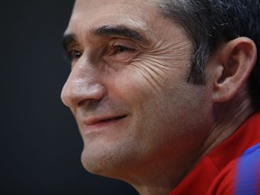 FILE - In this Monday, Dec. 4, 2017 file photo, FC Barcelona's coach Ernesto Valverde smiles during a training session at the Sports Center FC Barcelona Joan Gamper in Sant Joan Despi. In his first four months as Barcelona's coach, Valverde has helped the team recover from the shock exit of Brazil star Neymar in the summer and take a commanding lead of the Spanish league.