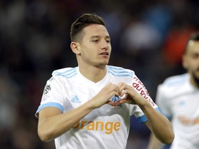 FILE - In this Sunday, Nov. 5, 2017 file photo, Marseille's Florian Thauvin celebrates after scoring during the League One soccer match between Marseille and Caen, at the Velodrome stadium, in Marseille, southern France. With Paris Saint-Germain streaking away at the top of the French league, the scrap for an automatic Champions League place promises to be an intense scrap between Monaco, Lyon and Marseille.