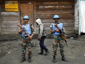 FILE - In this Friday Nov. 30, 2012 file photo, Two UN soldiers stand guard in Goma, Democratic Republic of Congo. Rebels attacked a United Nations peacekeeping base in eastern Congo, killing at least 14 peacekeepers and wounding 40 others Friday Dec. 8 2017, in the worst violence against the mission in this Central African country in years. Deputy spokesman Farhan Haq in New York said the peacekeepers were mainly from Tanzania, and that at least five Congolese soldiers also were killed in the assault blamed on one of the region's deadliest rebel groups.