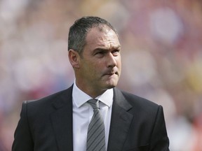 FILE - A Saturday, Aug. 26, 2017 file photo of Swansea City's manager Paul Clement as he looks at the stands before the English Premier League soccer match between Crystal Palace and Swansea City at Selhurst Park in London. Swansea fired Paul Clement Wednesday, Dec. 20, 2017, just before the manager completed a year in charge of the Premier League club.