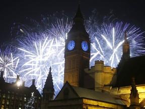 FILE - In this Friday, Jan. 1, 2016 file photo, fireworks explode over the River Thames and the Palace of Westminster's Elizabeth Tower, known as Big Ben, as the New Year's Day celebrations begin in London. London plans to beef up its police presence and close down some roads for New Year's Eve after a year marked by repeated extremist attacks. The Metropolitan Police said Thursday Dec. 28, 2017, there is no specific threat to the city's massive celebration, which is focused on a fireworks display over the River Thames, but says the public should be vigilant.