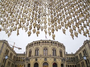 An art piece of 400 reindeer skulls by Sami artist Maret Anne Sara hang in front of the Parliament building in Oslo, Norway, Wednesday Dec. 6, 2017.