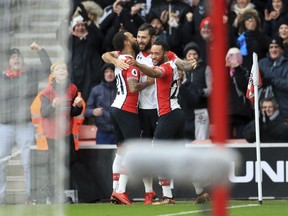 Southampton's Charlie Austin, centre, celebrates scoring his side's first goal of the game against Arsenal during their Premier League match at St Mary's Stadium, Southampton, England, Sunday Dec. 10, 2017.