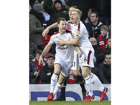 Burnley's Ashley Barnes, left, celebrates scoring his side's first goal of the game during the English Premier League soccer match against Manchester United at Old Trafford, Manchester, England, Tuesday, Dec. 26, 2017.