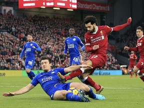 Leicester City's Harry Maguire, left, and Liverpool's Mohamed Salah battle for the ball during the English Premier League soccer match at Anfield, Liverpool, England, Saturday Dec. 30, 2017.
