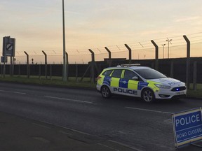 British police secure the perimeter outside RAF Mildenhall, England, after an incident and a suspect was arrested after a disturbance at the base, Monday Dec. 18, 2017.  The Midenhall airbase, about 80 miles (130 kilometers) north of London, is used by the U.S. Air Force, and was briefly locked down and a man was taken into custody after a disturbance Monday, police said.