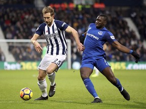 West Bromwich Albion's Craig Dawson, left, and Everton's Yannick Bolasie battle for the ball during the English Premier League soccer match at The Hawthorns, West Bromwich, England, Tuesday, Dec. 26, 2017.