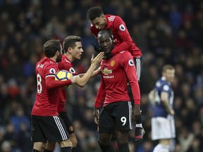 Manchester United's Romelu Lukaku, no. 9, celebrates scoring against West Bromwich Albion with teammates during their English Premier League soccer match at The Hawthorns, West Bromwich, England, Sunday Dec. 17, 2017.