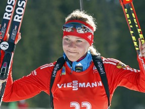 FILE - In this Sunday, March 9, 2014 file photo, Russia's Olga Zaitseva celebrates her third place in the women's 12.5km mass start at the biathlon World Cup competition in Pokljuka, Slovenia. The International Olympic Committee has disqualified three more Russian athletes from the 2014 Sochi Olympics for doping, including one of the country's greatest biathletes, it was reported on Friday, Dec. 1, 2017. (AP Photo/Darko Bandic, File)