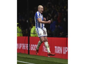 Huddersfield Town's Aaron Mooy celebrates scoring his side's fourth goal against Watford from the penalty spot during the English Premier League soccer match at Vicarage Road, Watford, Saturday, Dec. 16, 2017.